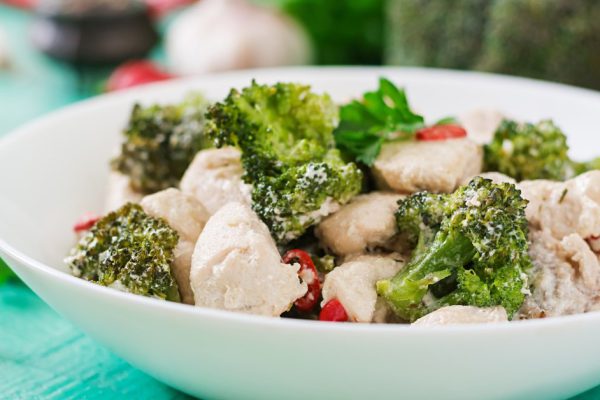 Delicate saute chicken with broccoli and chili peppers in a creamy garlic sauce