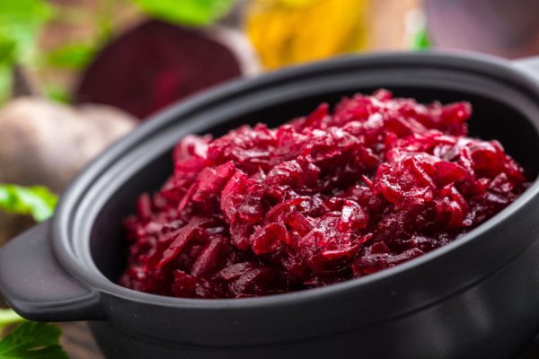 Beetroot salad on wooden background closeup