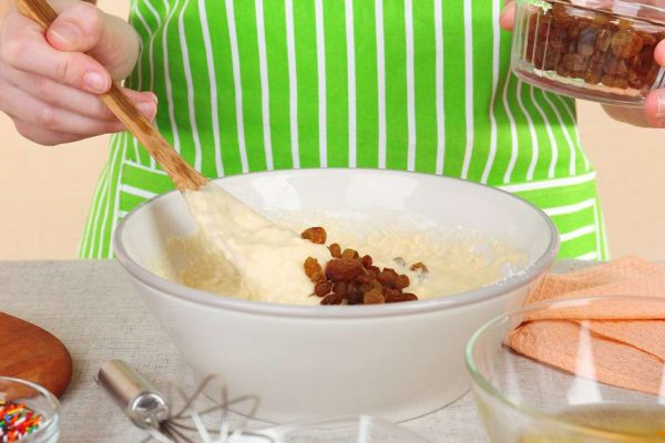 Woman preparing Easter cake in kitchen