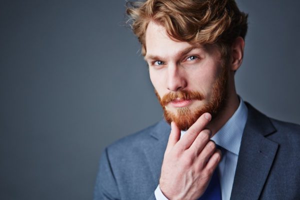 Confident businessman with beard looking at camera