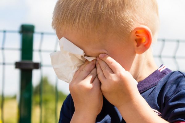 Emotions and feeling. Sad little boy crying, unhappy child wiping his eyes with tissue outdoor