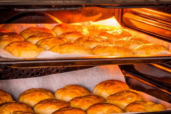 Hot oven with golden buns at a bakery