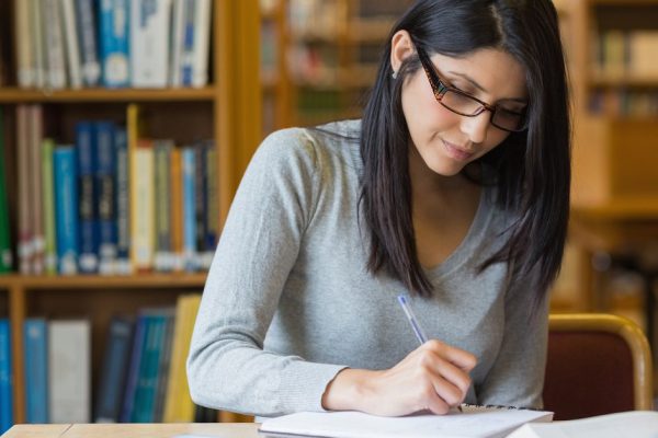 Black-haired woman studying in the library