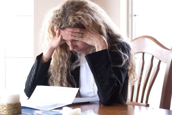 woman worried about bills and debt and foreclosure