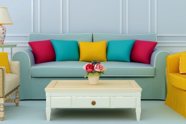 Beautiful composition of blue sofa and bright chairs with colorful pillows