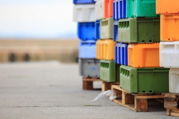 colorful boxes plastic crates. Packing containers piles for fish storage of catch.