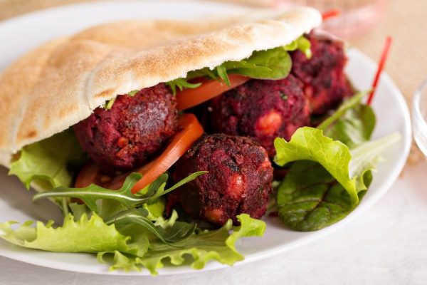 Beetroot falafel served with salad in a pita