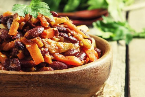 Baked beans with carrot, parsnip, onion and tomato, selective focus
