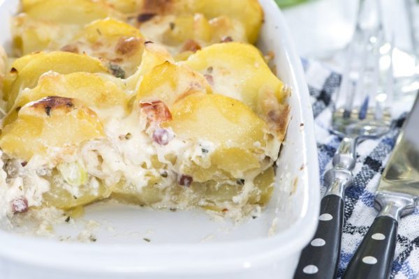 Fresh portion of homemade Potato Gratin with fresh herbs