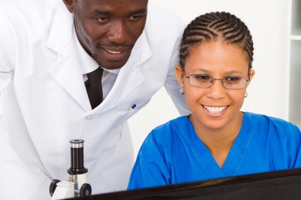 two african american scientists working in lab together