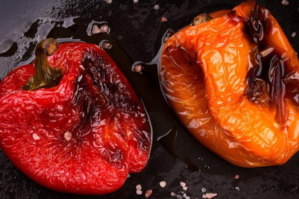Tasty roasted red and orange bell peppers in pan