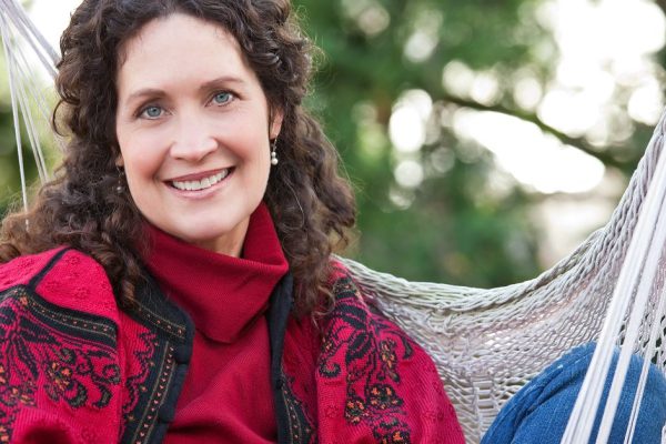 A beautiful mature woman sitting on a hammock
