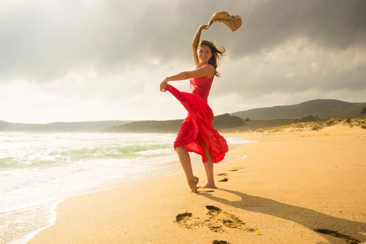 Девушка танцует на берегу