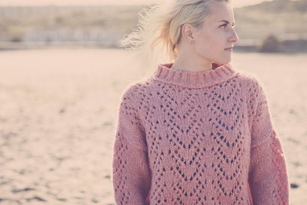 outdoor beach portrait of beautiful blonde caucasian model in outdoor vacation scenic place. sunny day and backlight for nice young girl in windy day. warm and yellow tones