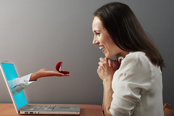 happy woman looking at ring